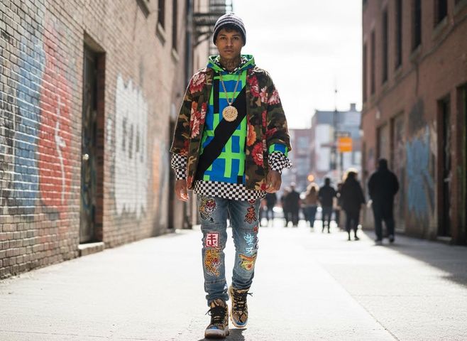 Man in intricate streetwear walking urban street