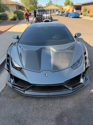 front of grey sports car