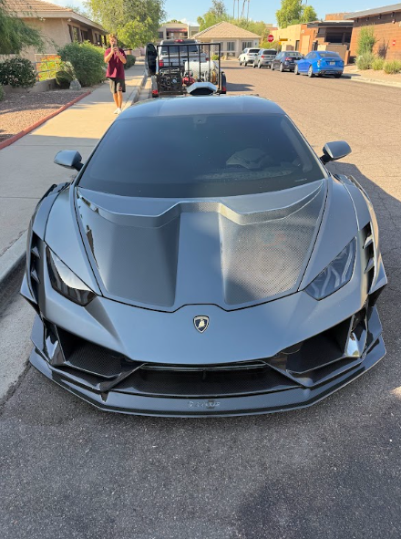 front of grey sports car