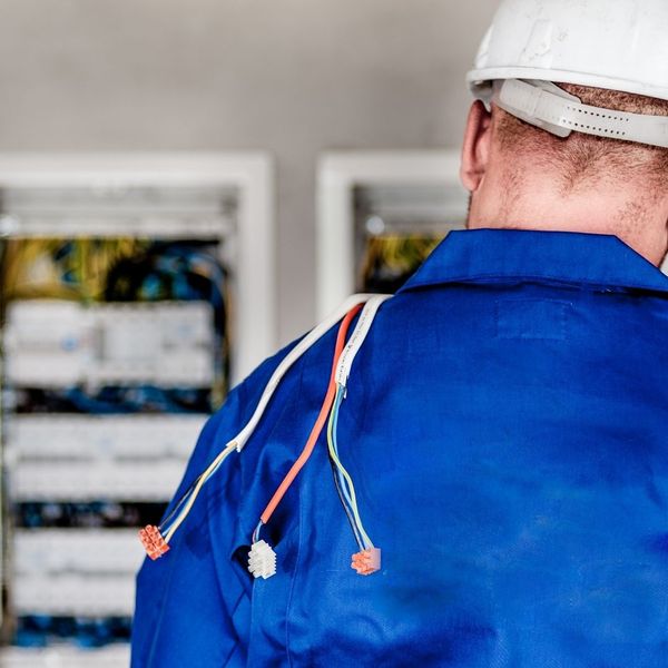 electrician working with breaker box
