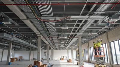 Modern commercial construction site showing professional electrical conduit installations on a high ceiling. Modern commercial construction site showing professional electrical conduit installations on a high ceiling.