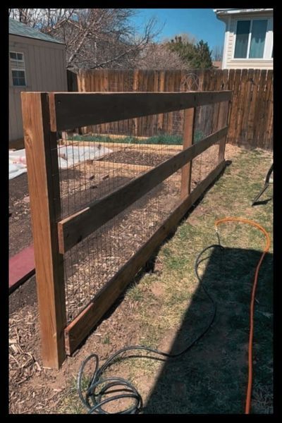 wooden fence with metal cattle fencing 