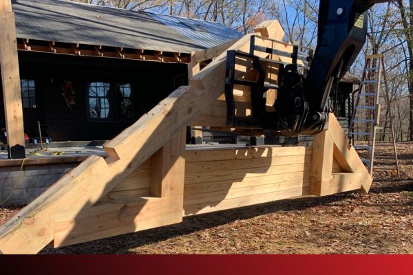 machinery lifting a wooden roof section