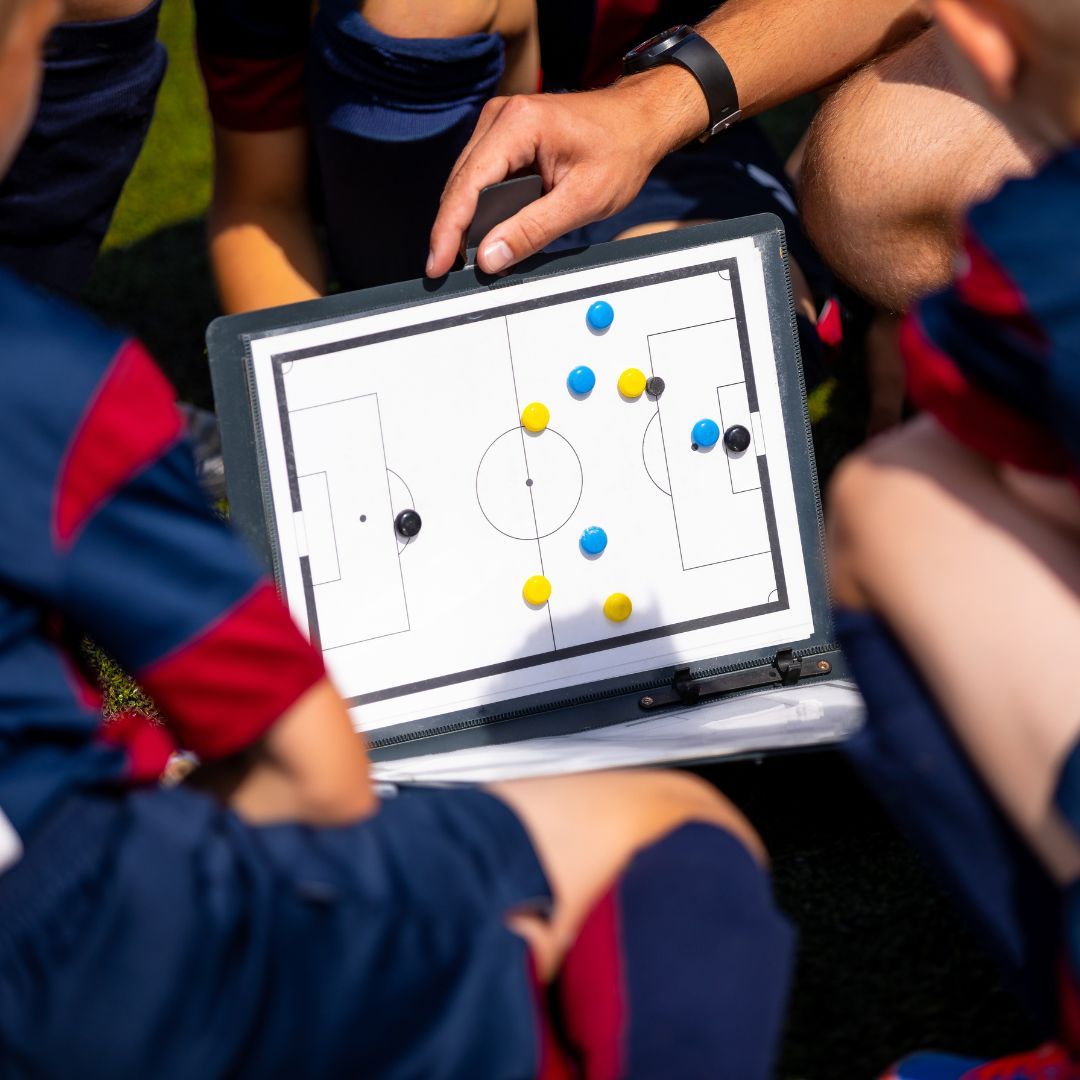 Soccer coach explaining the game to a team. Soccer coach explaining the game to a team.