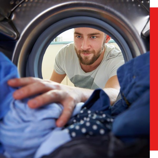 view from inside washer looking out at man putting clothes in view from inside washer looking out at man putting clothes in