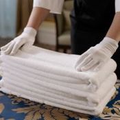 person folding white towels