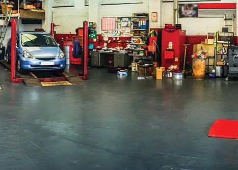 an auto shop's concrete floor with some oil stains
