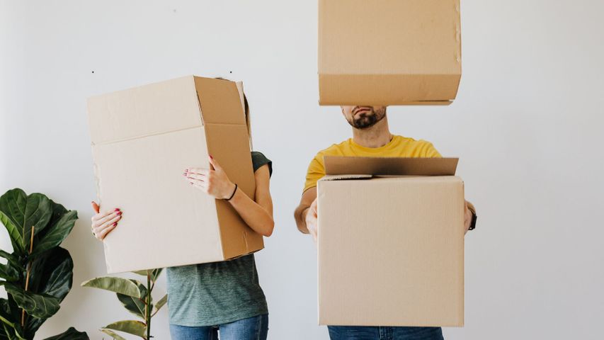 two people holding boxes