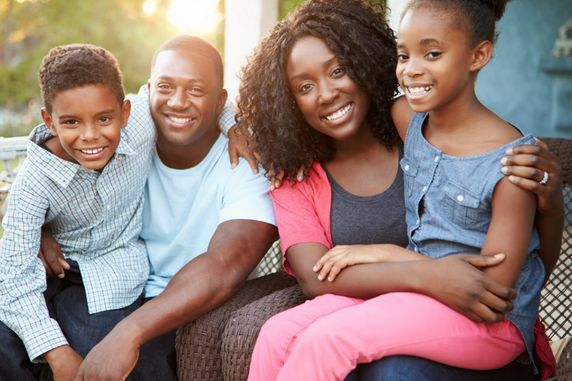 Happy family smiling while sitting outside