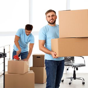 Movers smiling moving boxes