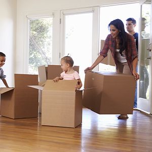 Family moving boxes into their new home