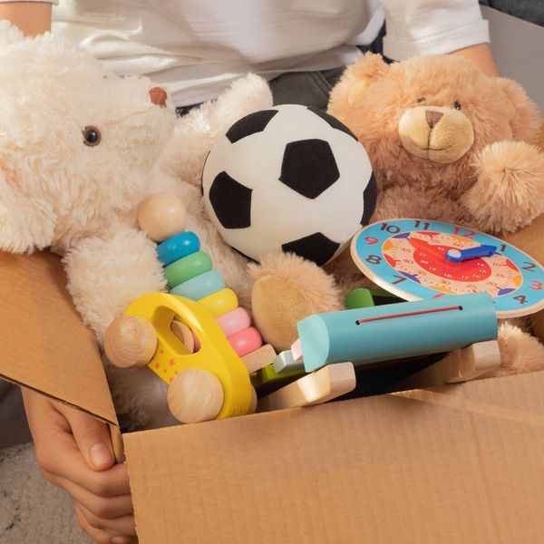 A packed box full of toys and kids supplies