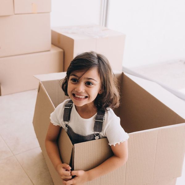 little girl in moving box