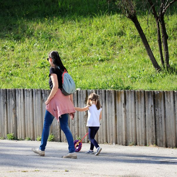 Adult and little girl walking around town