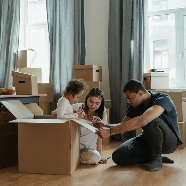 family packing boxes with young child