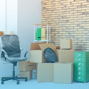 Stacked moving boxes in an office