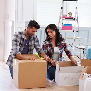 Couple packing and labeling boxes