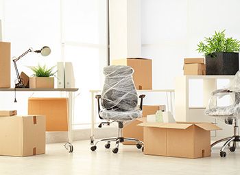 Stacked moving boxes in an office