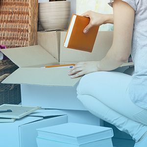 Woman packing books into a box