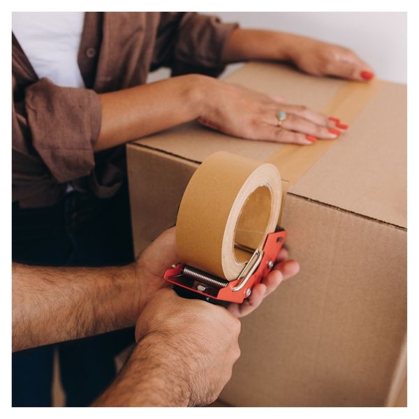 Man taping shut a carboard box