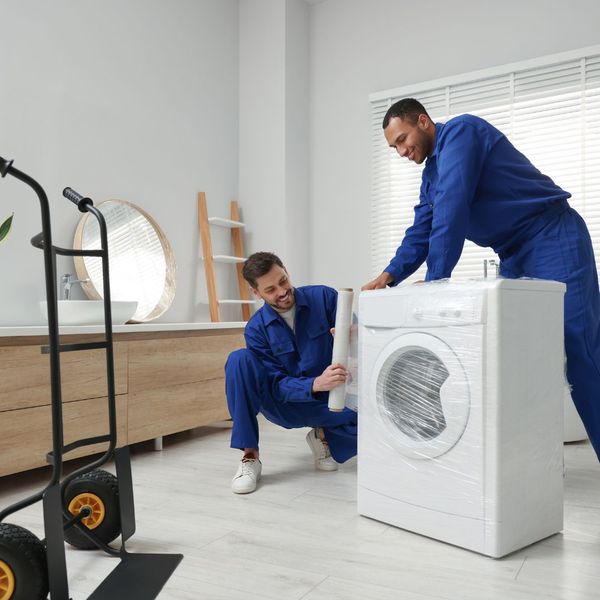 movers packing a washing machine