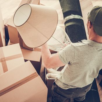 Man packing his items in boxes for a move