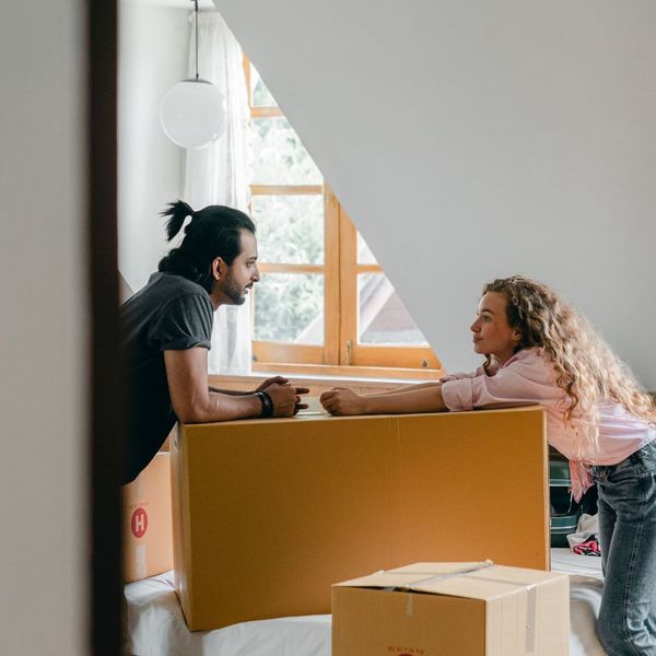 two people leaning on moving box