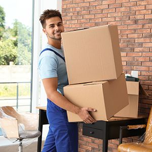 Mover moving boxes in office