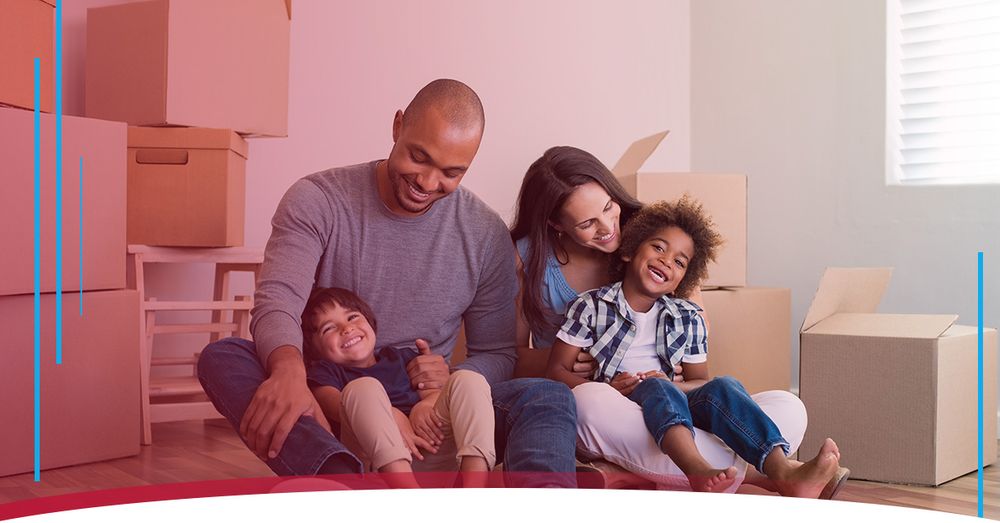 Family sitting on the floor surrounded by moving boxes