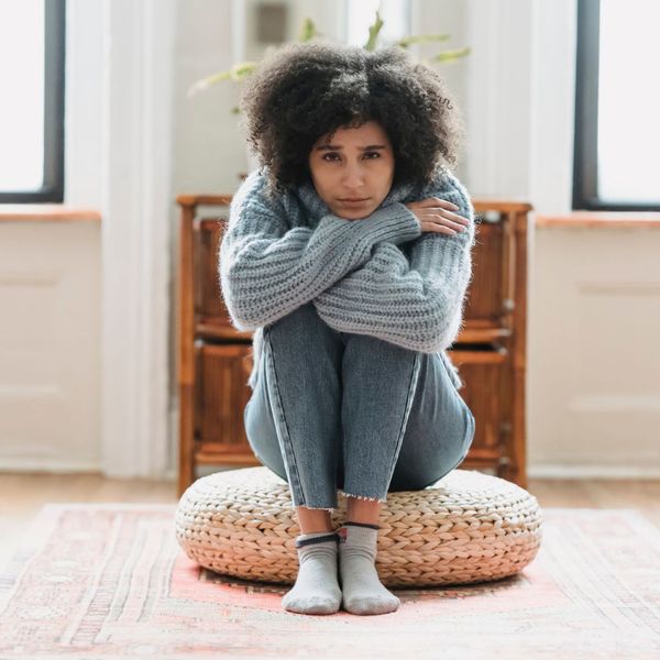 sad woman sitting on floor