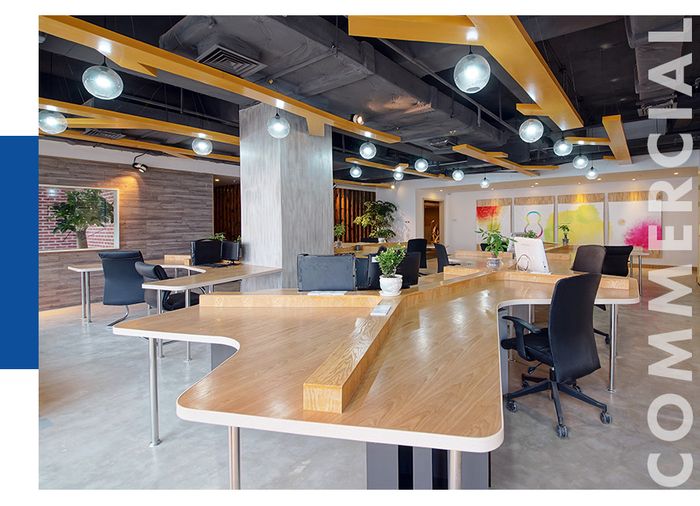 a modern office space with wood, open concept desks and black chairs