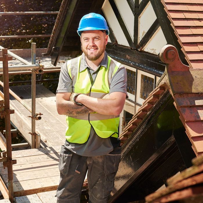 construction worker standing on roof