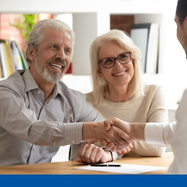couple shaking hands with attorney couple shaking hands with attorney