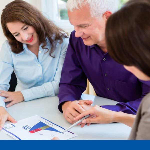 couple looking over financial documents with attorney couple looking over financial documents with attorney