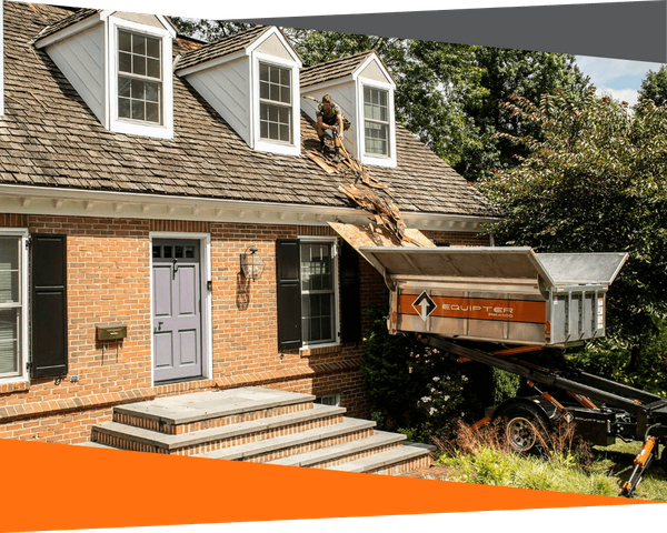 equipter collecting debris from roof