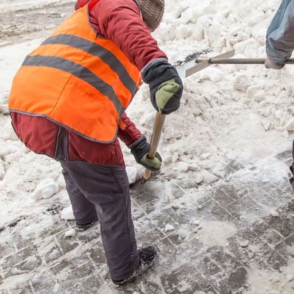 Worker shoveling snow