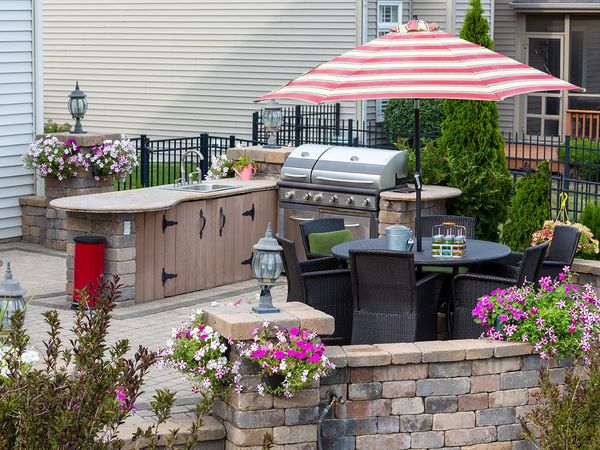 Custom outdoor kitchen with grill and garden