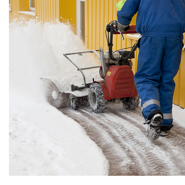 man snowplowing a walk way