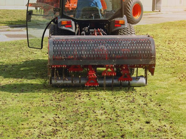 Lawn aeration tractor rolling over a lawn