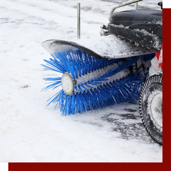 snow plow clearing a sidewalk