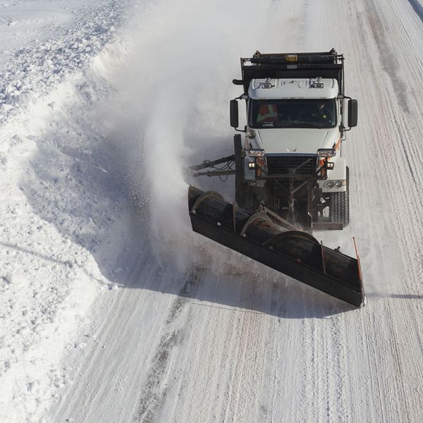 white snow plow doing work