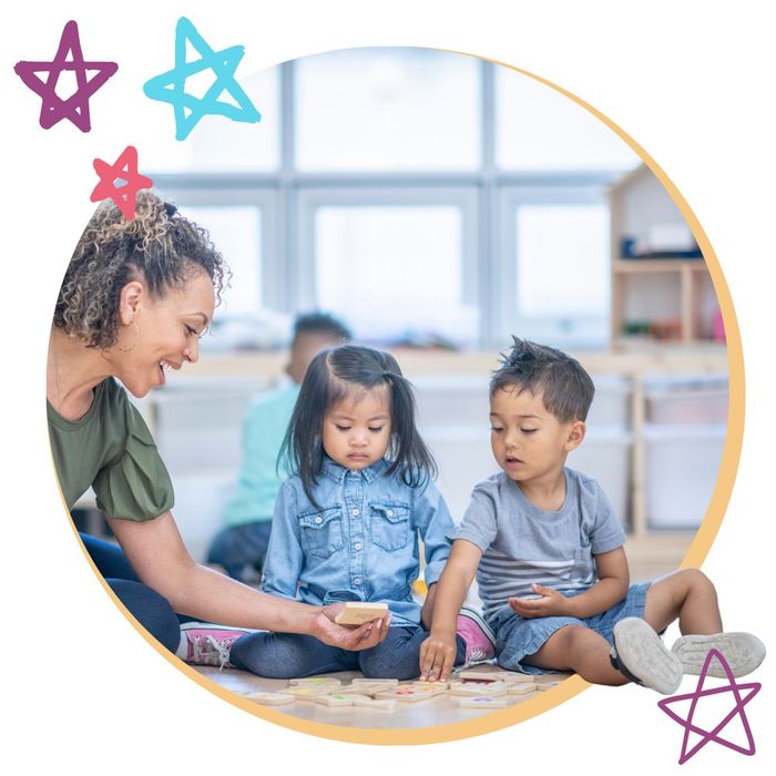 a daycare worker playing matching tiles with two children