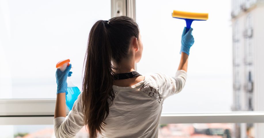 Image of a woman cleaning windows