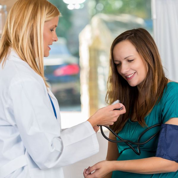 a doctor taking a woman's blood pressure