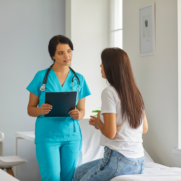 A nurse speaking to a patient