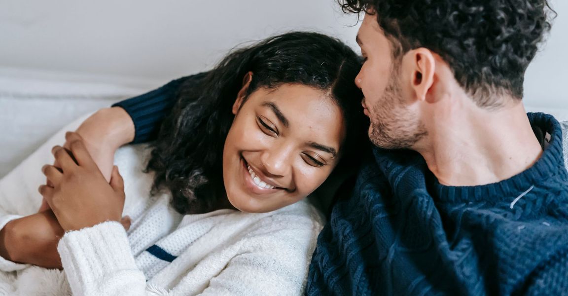 couple cuddling on a couch