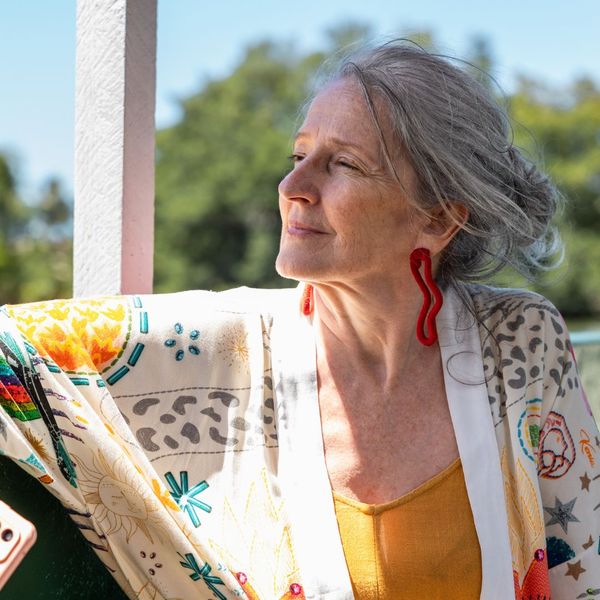 An older woman sitting outside. An older woman sitting outside.