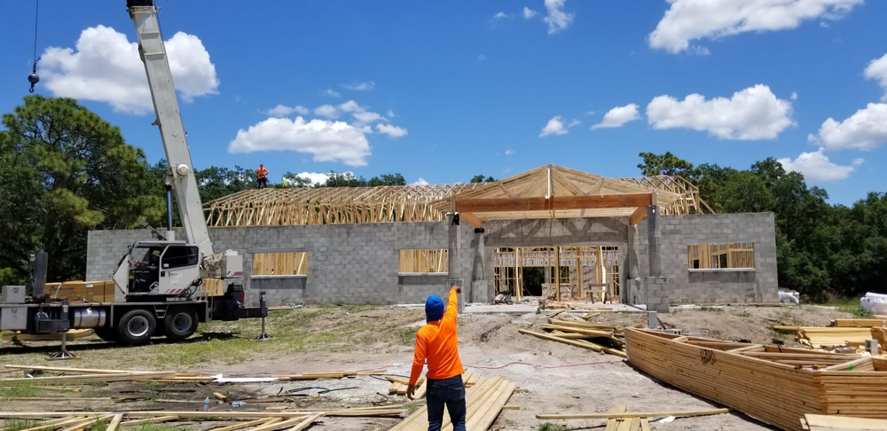 construction worker outside of house being built