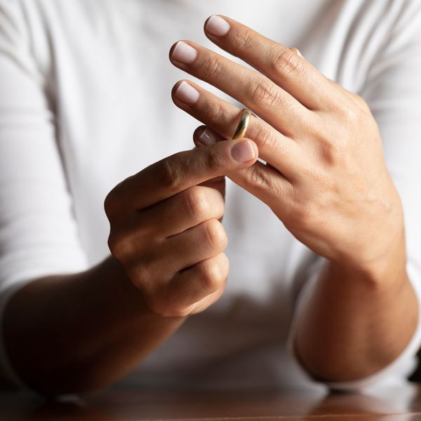 woman taking off wedding band