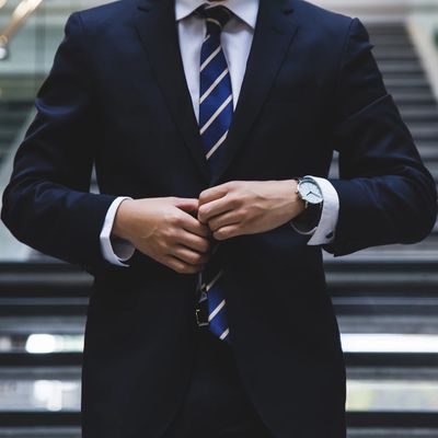 businessman buttoning a suit jacket